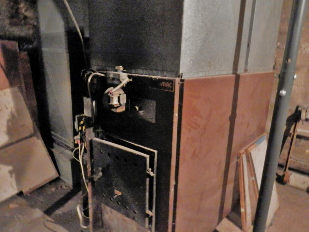 13799 Springdale Road Thompsonville, MI 49683 - Photo 23 of 34 Gas furnace behind this woodburner
