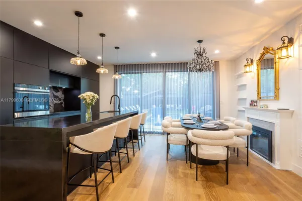 a kitchen with a table chairs stove and kitchen view