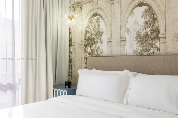 a bed room with furniture and paintings on the wall