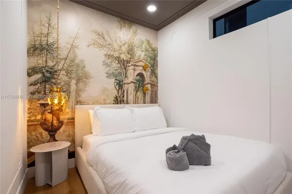 a bedroom with a bed and a flat screen tv