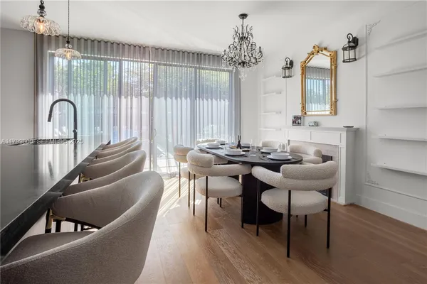 a kitchen with sink a faucet and chairs