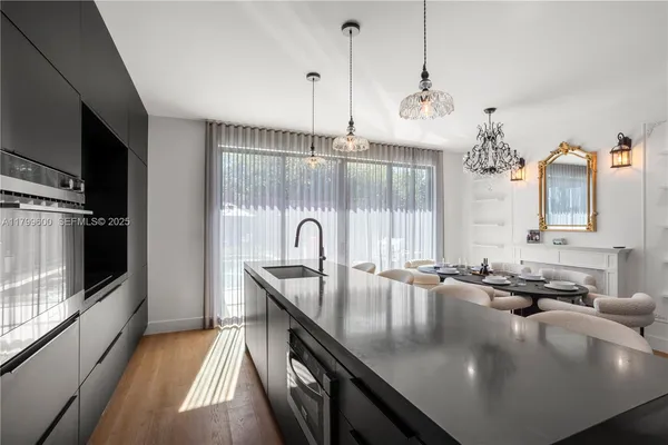 a dining room with furniture a chandelier and window