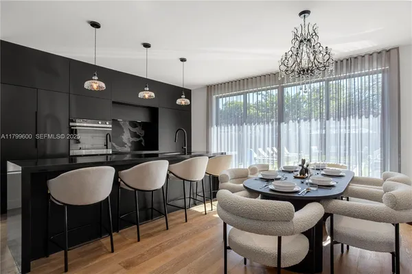 a kitchen with a table chairs and microwave