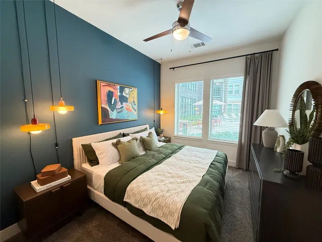 a bed sitting in a bedroom next to a window