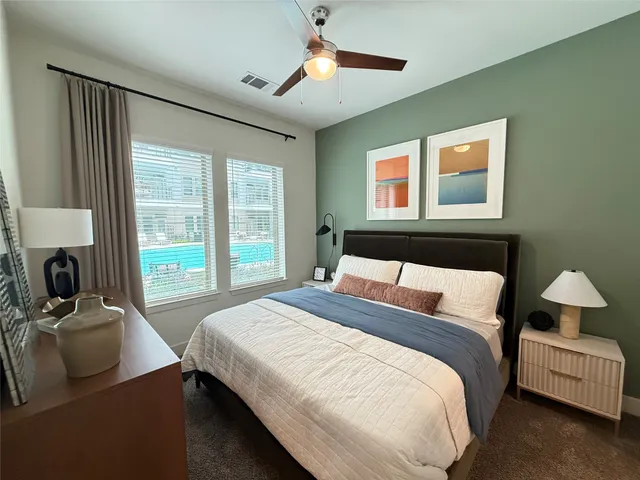 a bedroom with bed and window