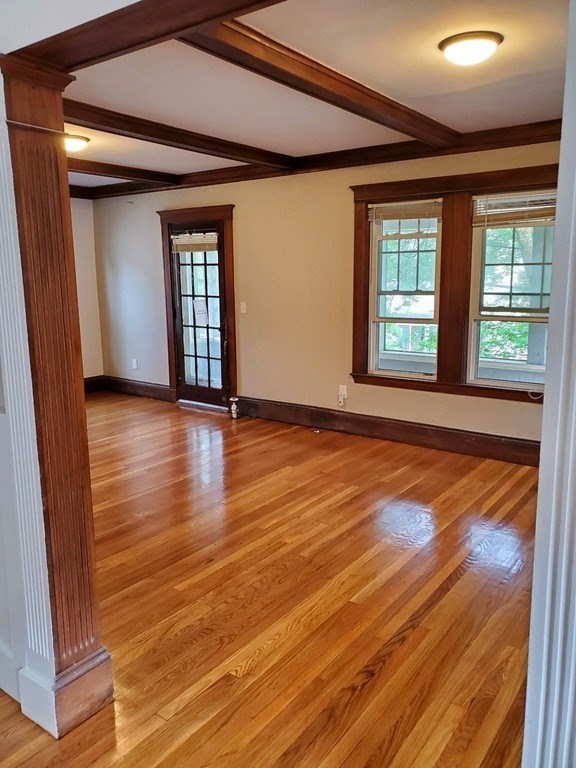 22 Allen Street, Unit 2 Arlington, MA 02474 - Photo 5 of 25 a view of an empty room with wooden floor and a window