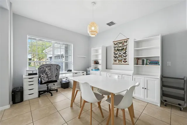 a living room with furniture kitchen view and a chandelier