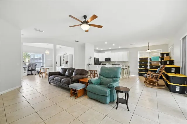 a kitchen with granite countertop white cabinets stainless steel appliances and a counter space