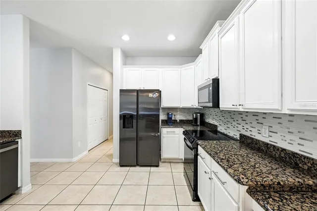 a bathroom with a shower curtain sink and a toilet