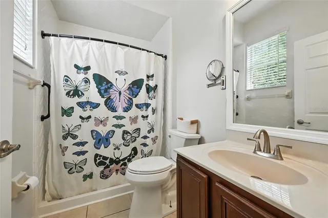 a spacious bathroom with a tub sink shower and mirror