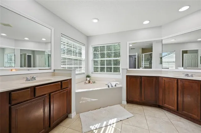 a bedroom with a bed and a flat tv screen on dresser