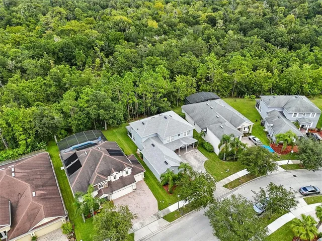 an aerial view of a house with a swimming pool yard and outdoor seating