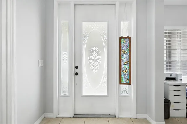 a view of front door with hallway and stairs