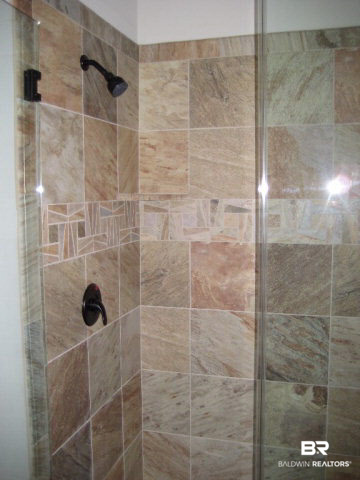 11778 Lodgepole Court Daphne, AL 36527 - Photo 9 of 16 slate look tile shower with heavy frameless shower enclosure and Pfister Tuscan bronze faucet