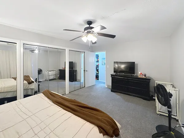 a bedroom with a bed and a tv