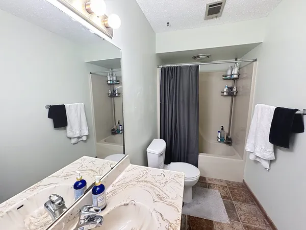 a bedroom with a bed and flat screen tv