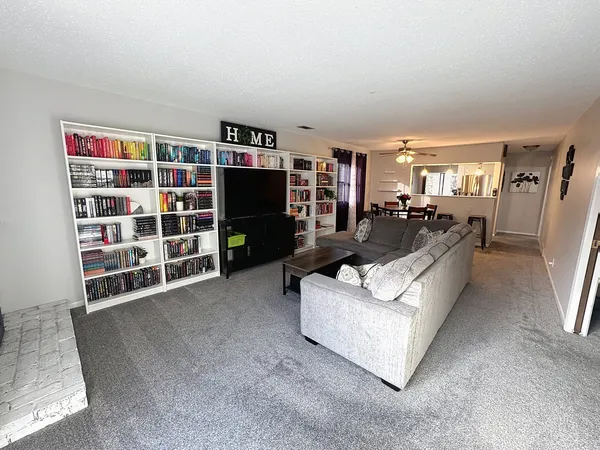 a living room with furniture and a book shelf