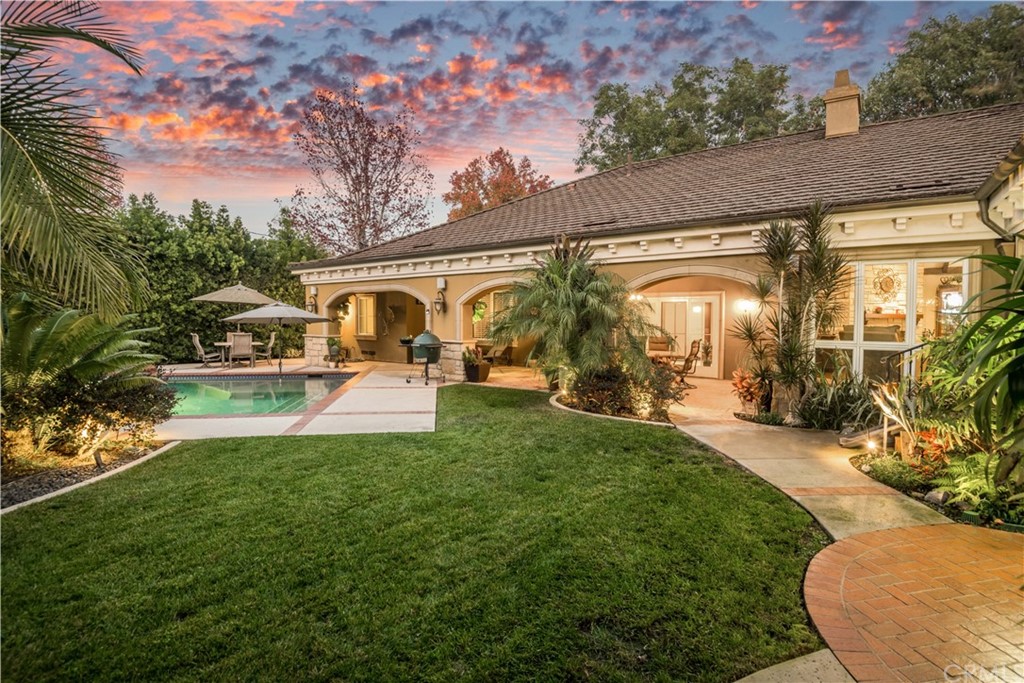 1455 Bryant Drive Long Beach, CA 90815 - Photo 5 of 6 a view of a patio with table and chairs under an umbrella