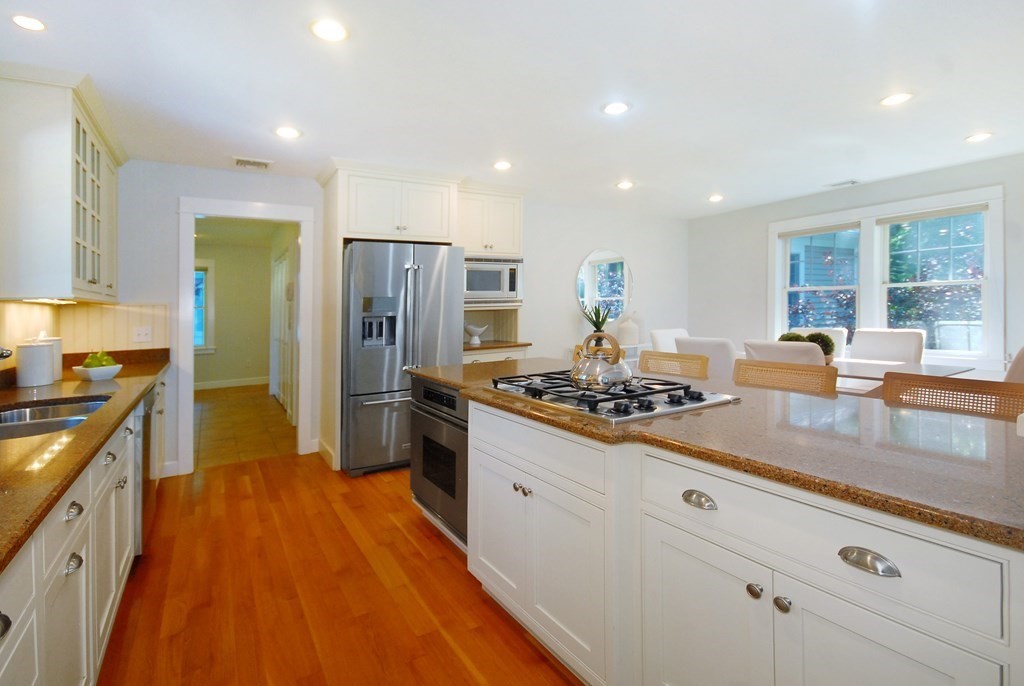 118 Monsen Road Concord, MA 01742 - Photo 11 of 34 a kitchen with kitchen island granite countertop a sink stove and refrigerator