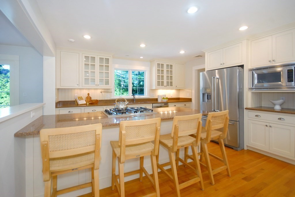 118 Monsen Road Concord, MA 01742 - Photo 12 of 34 a kitchen with stainless steel appliances kitchen island granite countertop a refrigerator and cabinets