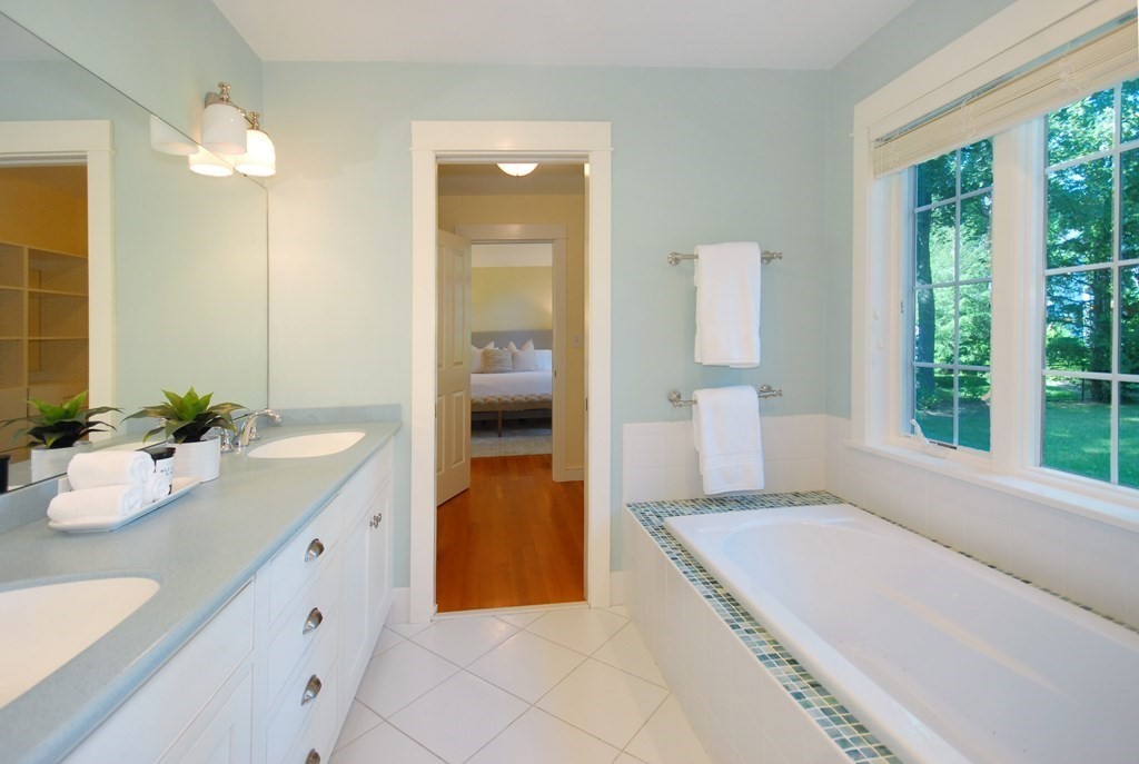 118 Monsen Road Concord, MA 01742 - Photo 21 of 34 a spacious bathroom with a granite countertop sink and a mirror