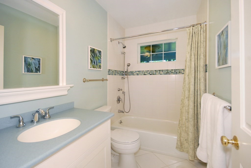118 Monsen Road Concord, MA 01742 - Photo 23 of 34 a bathroom with a granite countertop toilet a sink and a mirror