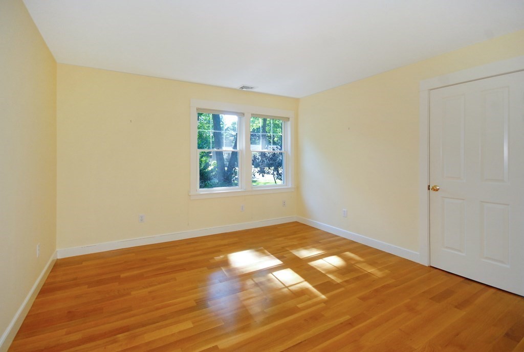 118 Monsen Road Concord, MA 01742 - Photo 24 of 34 a view of an empty room with wooden floor and a window