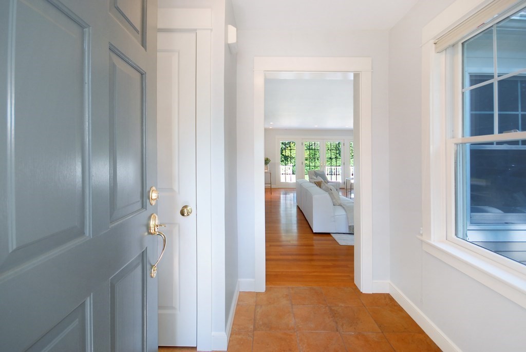 118 Monsen Road Concord, MA 01742 - Photo 3 of 34 a view of a hallway with wooden floor and a dining room
