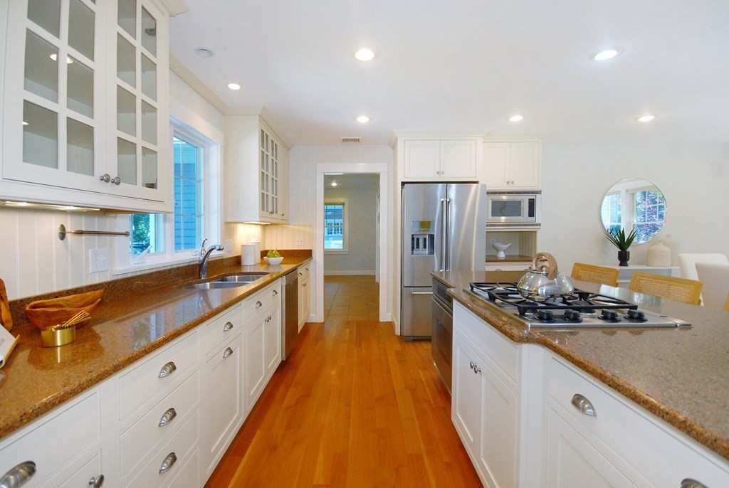 118 Monsen Road Concord, MA 01742 - Photo 10 of 34 a kitchen with stainless steel appliances kitchen island granite countertop a stove and a refrigerator