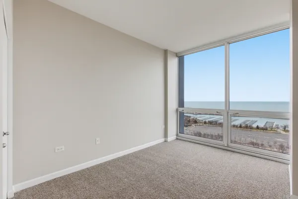 an empty room with sliding door and mountain view