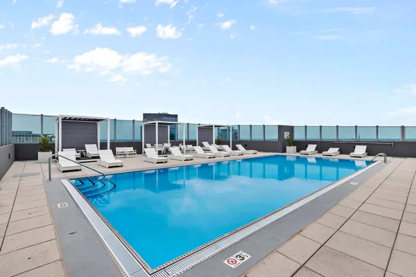 a view of swimming pool with outdoor seating and plants
