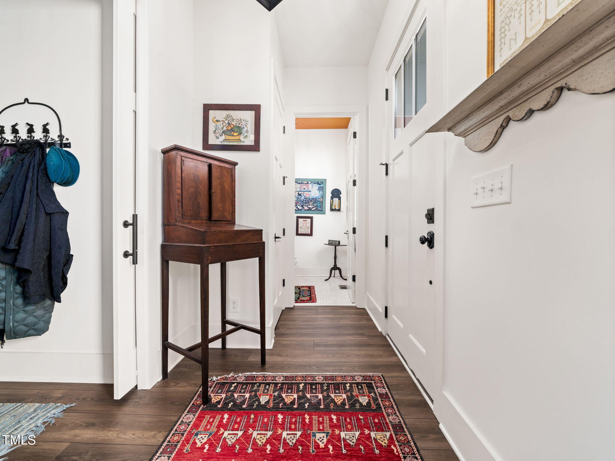 1422 Milton Road Durham, NC 27712 - Photo 42 of 73 a view of a hallway to a livingroom with wooden floor and furniture