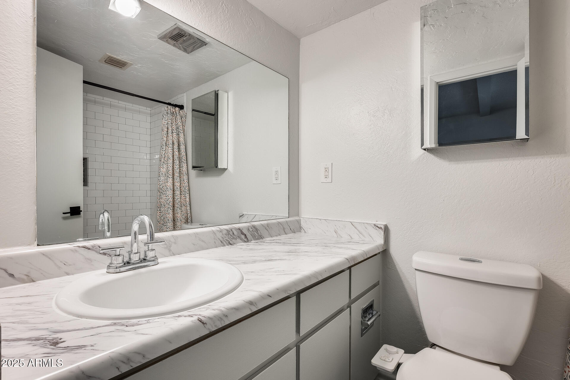 1024 East Osborn Road, Unit A Phoenix, AZ 85014 - Photo 12 of 20 a bathroom with a granite countertop toilet sink and mirror
