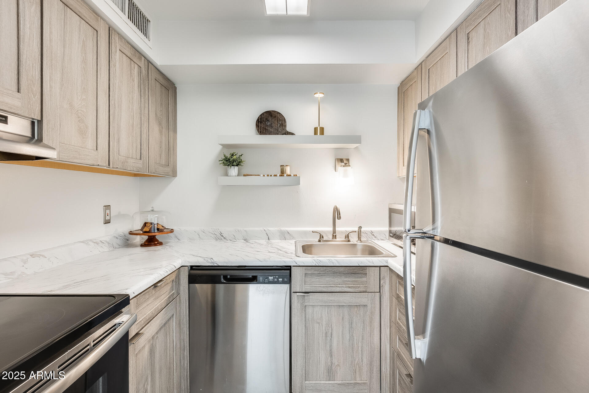 1024 East Osborn Road, Unit A Phoenix, AZ 85014 - Photo 3 of 20 a kitchen with stainless steel appliances granite countertop a sink refrigerator and cabinets