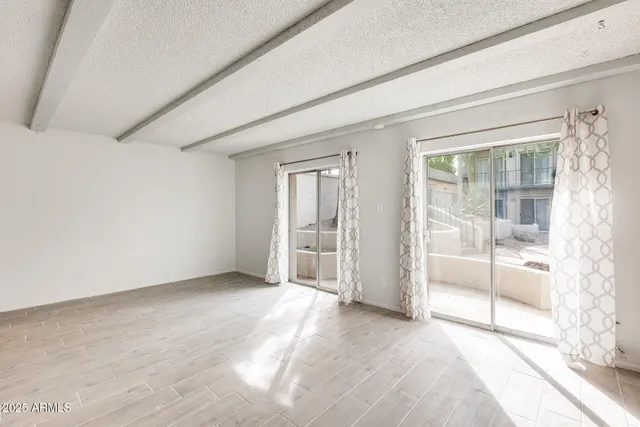 a kitchen with stainless steel appliances granite countertop a sink refrigerator and cabinets