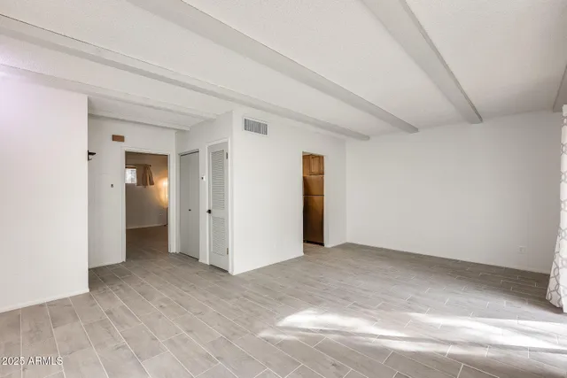 an empty room with sliding glass door and shower