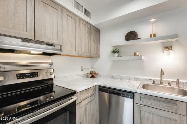 a view of a kitchen with a sink and an oven