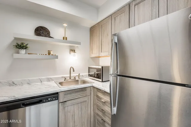 a kitchen with a sink cabinets and stainless steel appliances