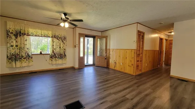 a view of a workspace with wooden floor and furniture
