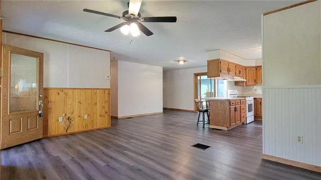 a kitchen with stainless steel appliances granite countertop a stove a sink and a refrigerator