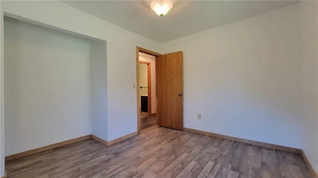 a view of a room with wooden floor and bathroom view