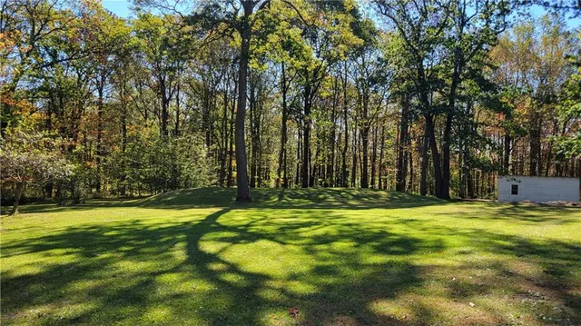 a swimming pool with trees in the background