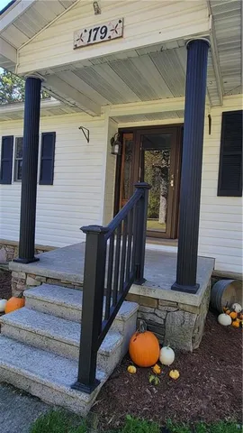 a kitchen with kitchen island a counter top space a sink a refrigerator and cabinets
