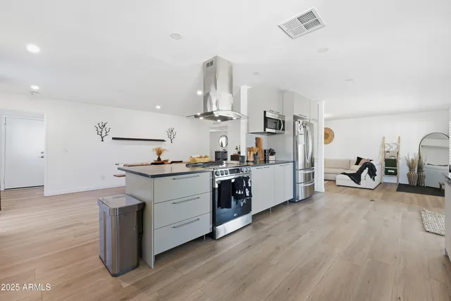 a kitchen with sink cabinets and wooden floor