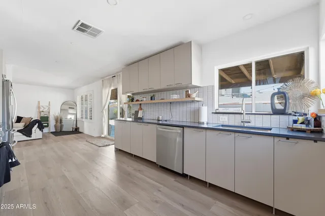 a kitchen with stainless steel appliances granite countertop a sink and cabinets