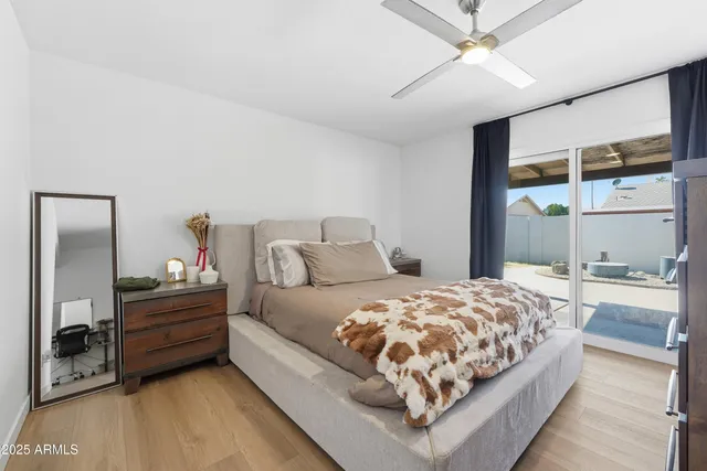 a bedroom with a bed and large window