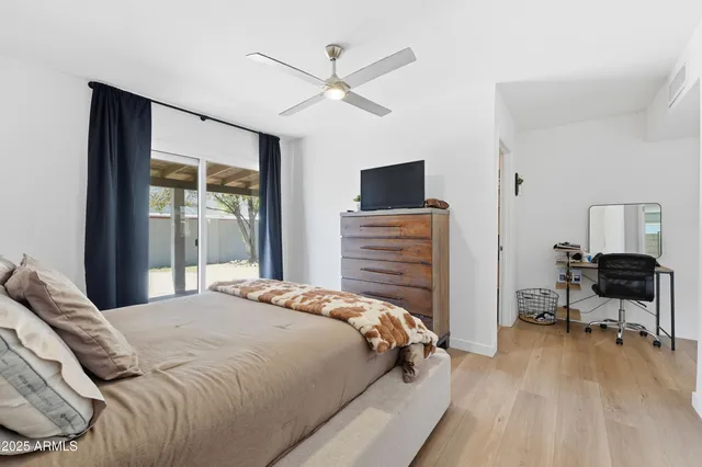 a bedroom with a bed and a television