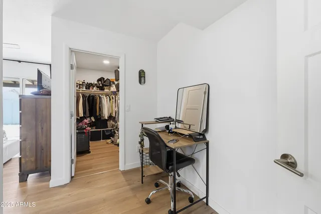 a view of a workspace with furniture and wooden floor