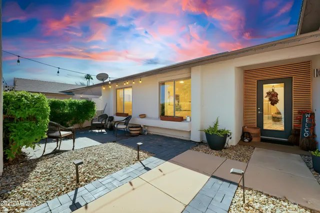 a building outdoor space with patio furniture and potted plants