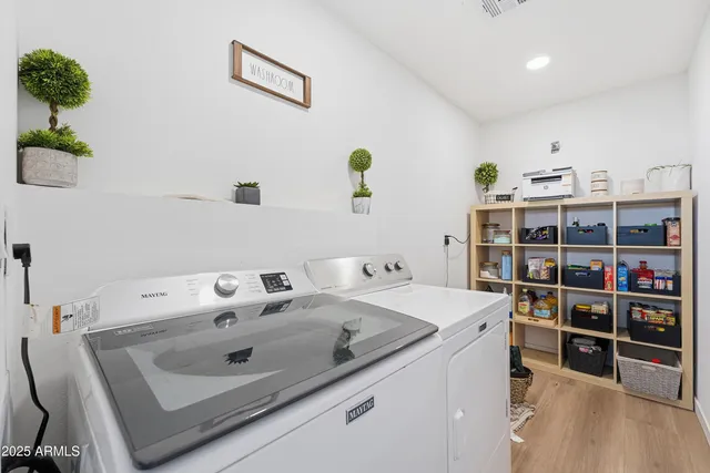 a utility room with a sink dryer and bicycles